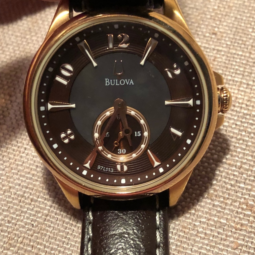 Bulova gold watch with brown leather strap